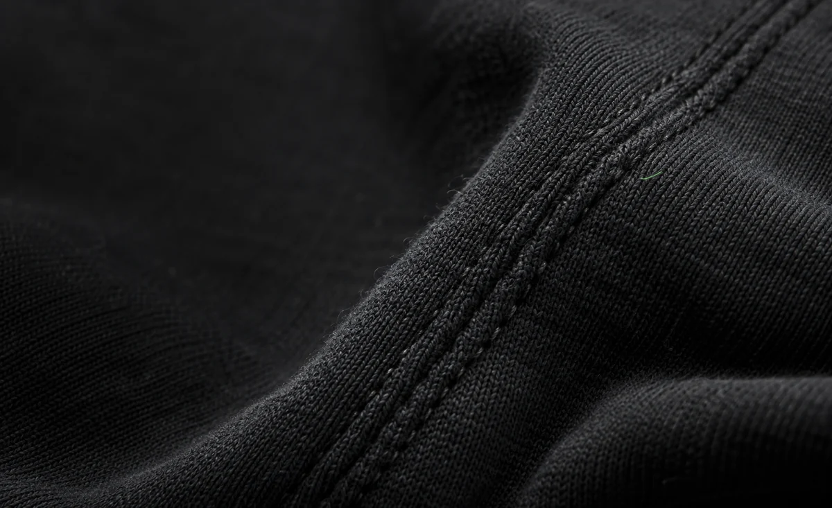 Dark fabric and green stitching