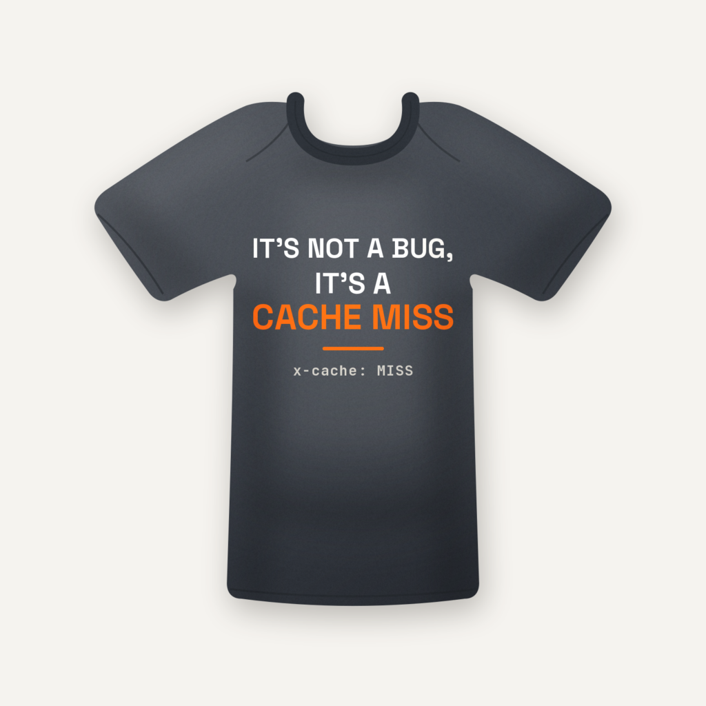 It's Not a Bug, It's a Cache Miss tee in charcoal, flat lay