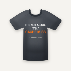 It's Not a Bug, It's a Cache Miss tee in charcoal, flat lay